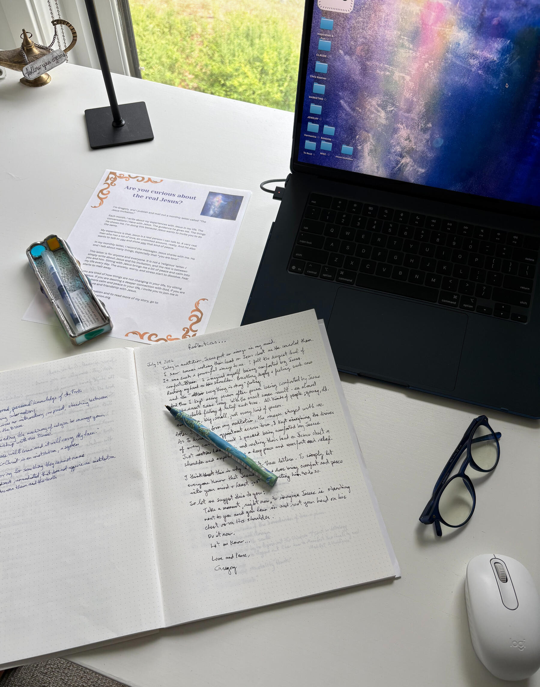Laptop displaying The Jesus Invitation website next to a handwritten journal and printed flyer
